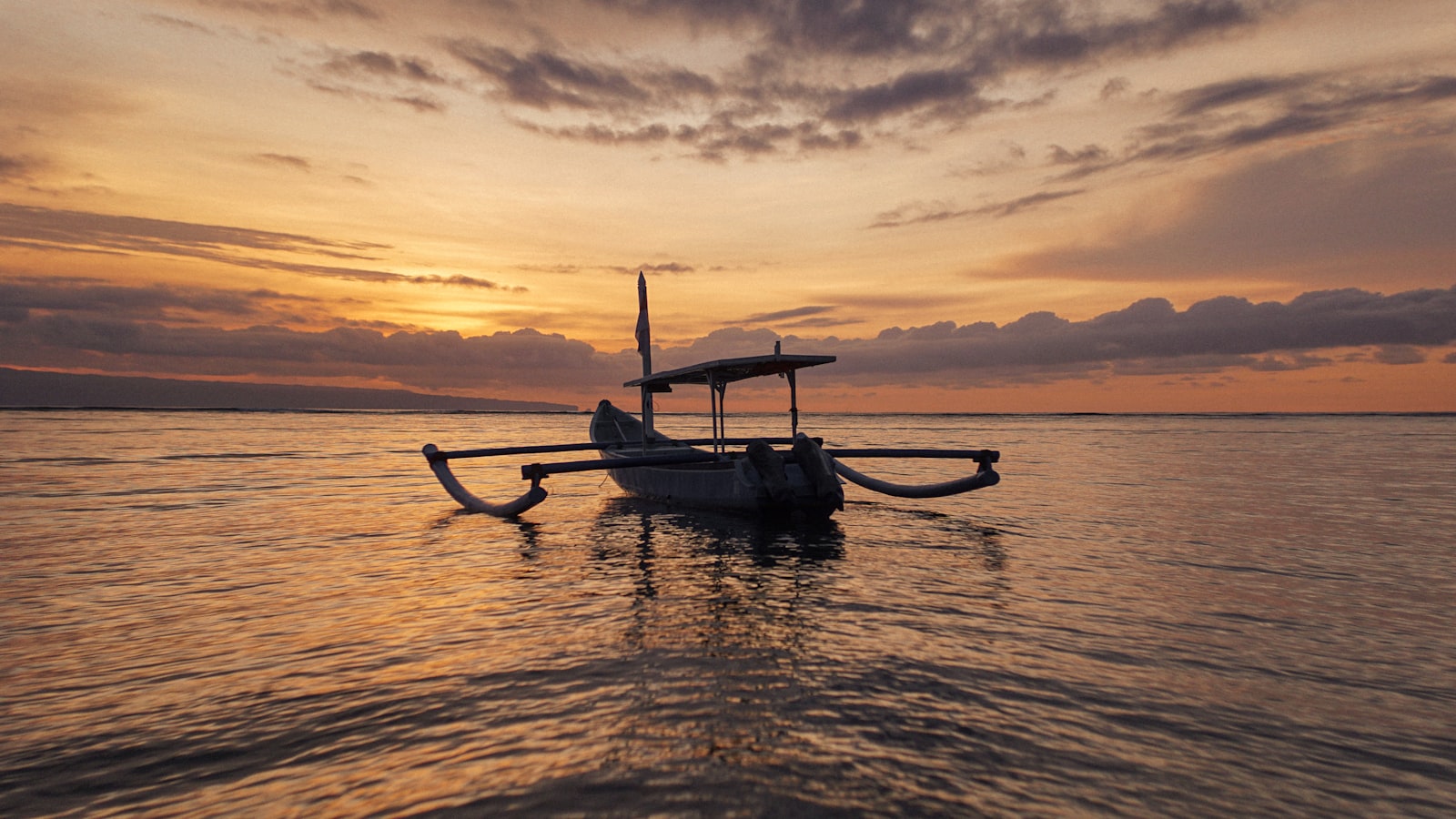 a boat floating on top of a large body of water